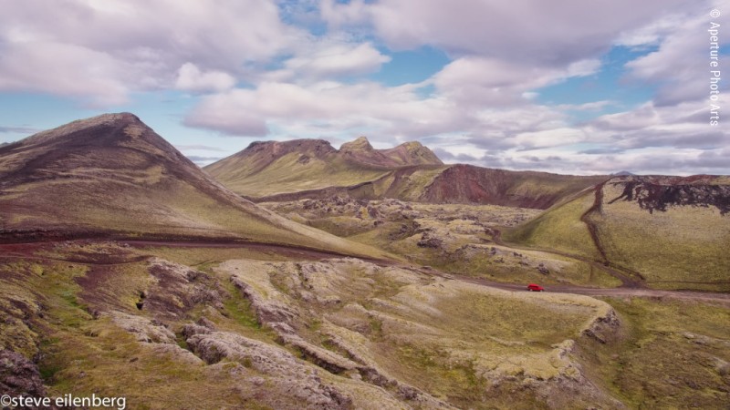 Red car and mountains. Iceland interior