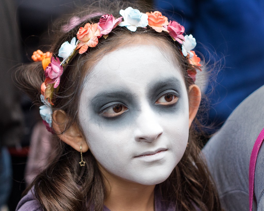 Street photography, festival, town square, Young girl getting ready for day of the dead celebration, San Miguel de Allende