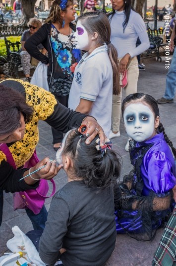 Girls getting face paint. Dia de los Muertos. San Miguel de Allende