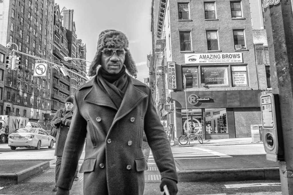 Black man strutting,   sunglasses, Street photography, NYC  on