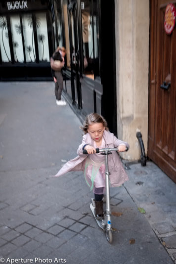 Little girl, black eye, scooter, Paris France