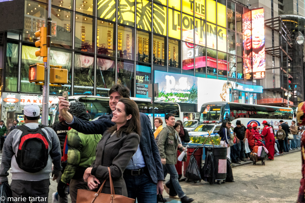 Couple takes selfie photo in Times square in NYC