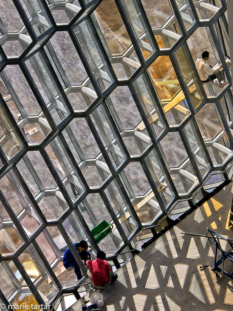 Construction workers put finishing touches on Harpa concert hall, Reykjavik