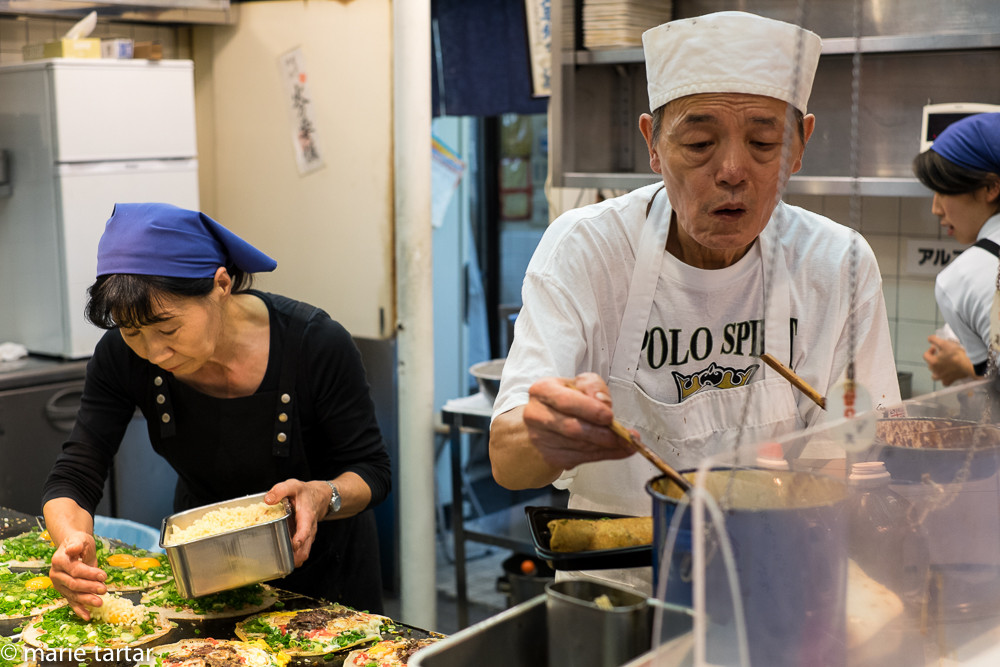 Hard working couple assembles okinomiyaki at Issen in Kyoto