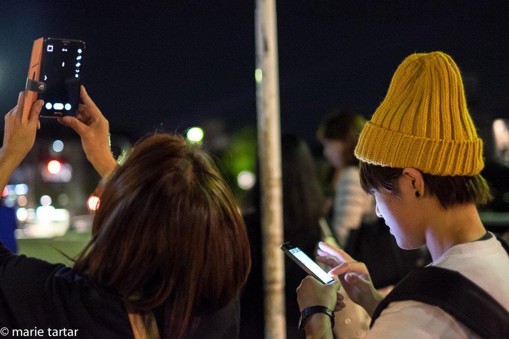 Kyoto residents trying to capture blood moon with eclipse with cell phone cameras