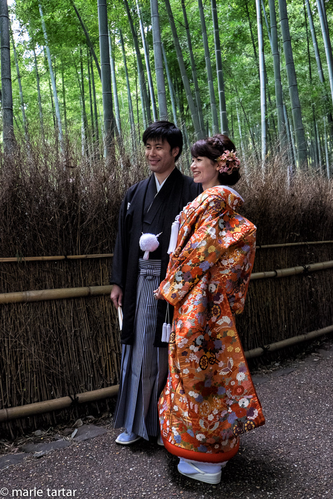 Handsome couple having wedding photos taken in Arashiyama bamboo forest in western Kyoto