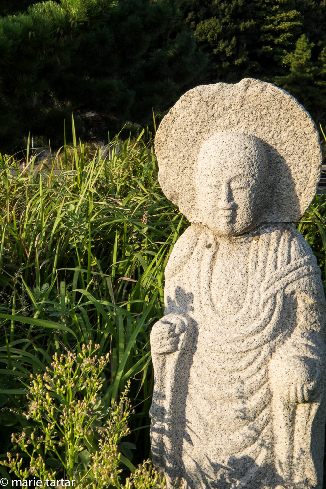 Buddha in field at Naoshima Island, near Benesse House