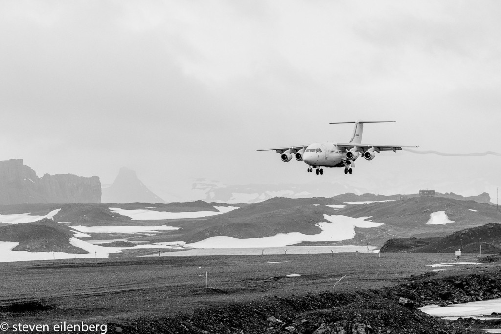 Airplane lands on dirt airstrip in Antarctica at Frei Station on King George Island