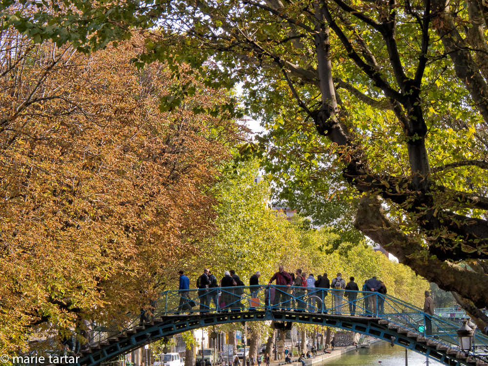 A glorious fall day in 2011 along the Canal Saint-Martin; my brother-in-law Jason is in red in the center of la passerelle (footbridge)