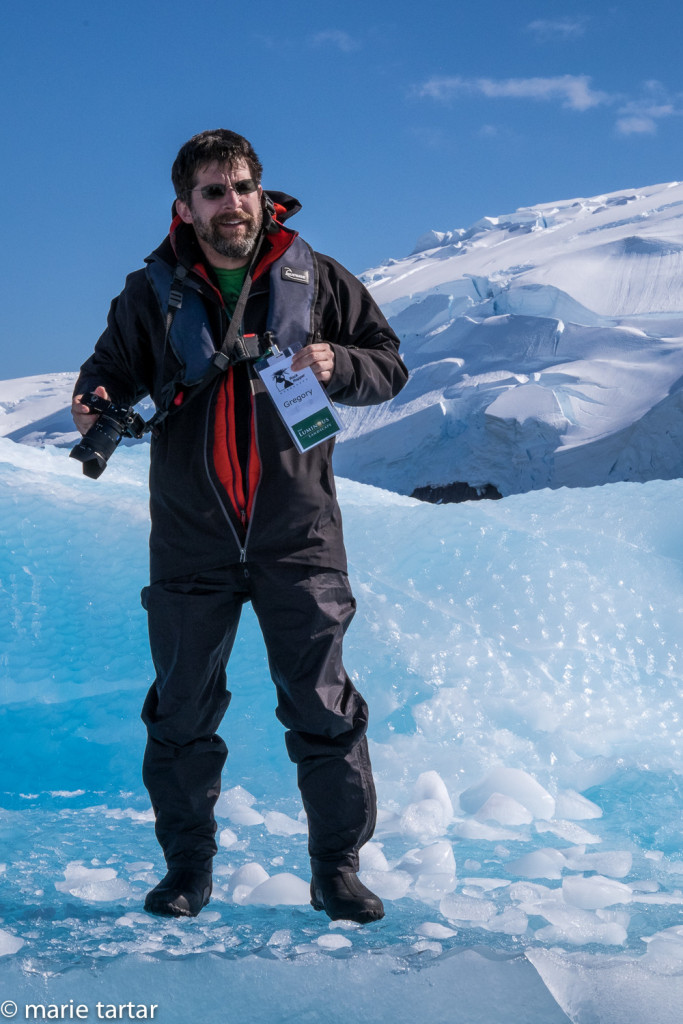 Greg, our favorite travel companion, shows how to walk on an iceberg: carefully, with your nametag