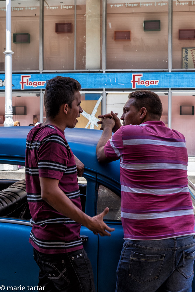 Havana residents and vintage car in Havana Centro