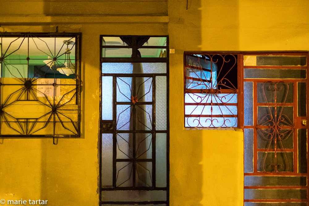Decorative metalwork adorning windows and doors in Havana, Cuba