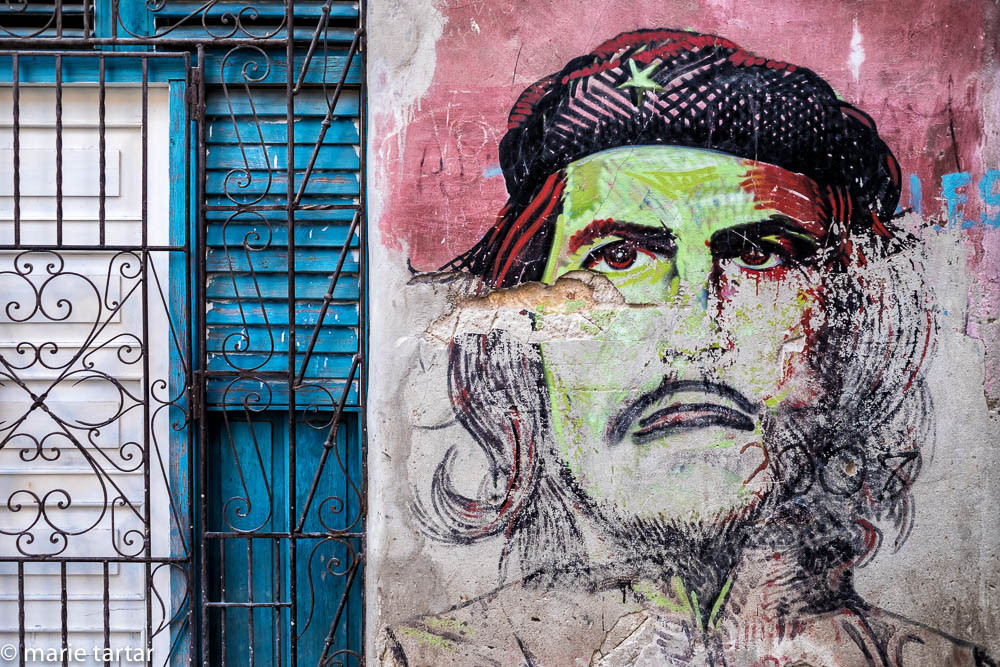 I couldn't bring myself  to photograph the drab buildings in Plaza de la Revolución, 5 story tall likeness of Ché or no; same for most of the propagandist billboards; this colorful graffiti version of Ché was taken in Havana Vieja