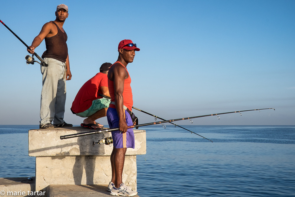 Fishermen at work on the Malecón, the signature seaside promenade of Havana