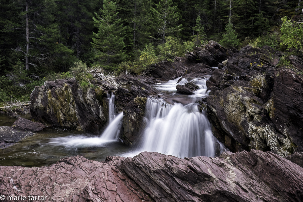 Red Rock Falls is an attraction on the Swiftcurrent Nature Trail in Glacier National Park, near Many Glacier