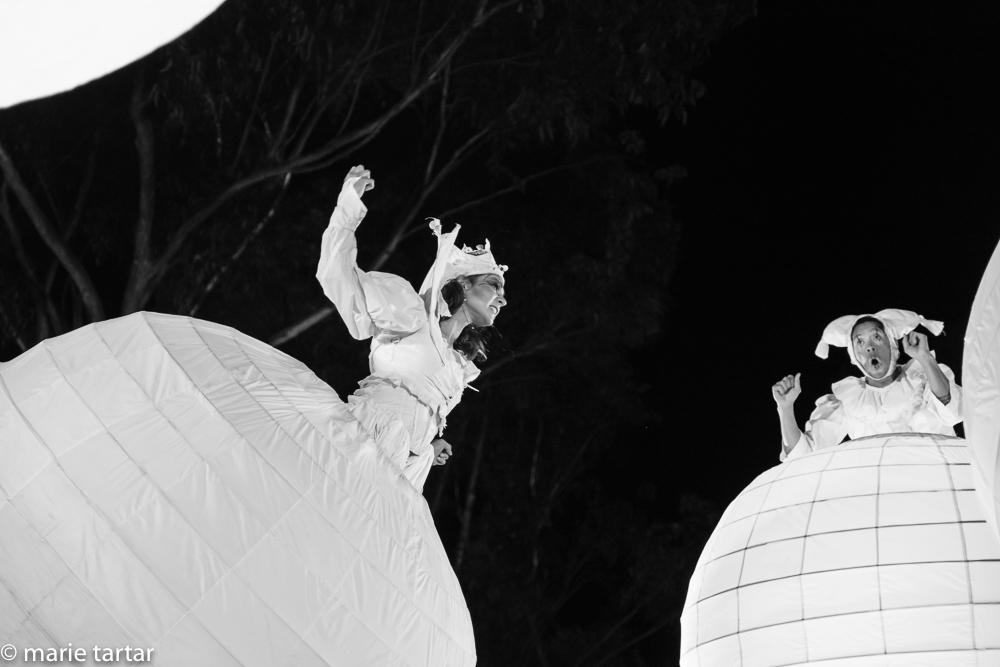 The "wicked witch" performer and "the baby" (my names) soar through the air overhead in "Spheres."