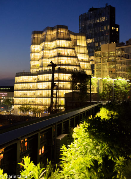 Frank Gehry's IAC building in Chelsea, lit at night, seen from the Highline
