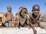 HImba boys playing in the bed of an abandoned truck bed in northern Namibia