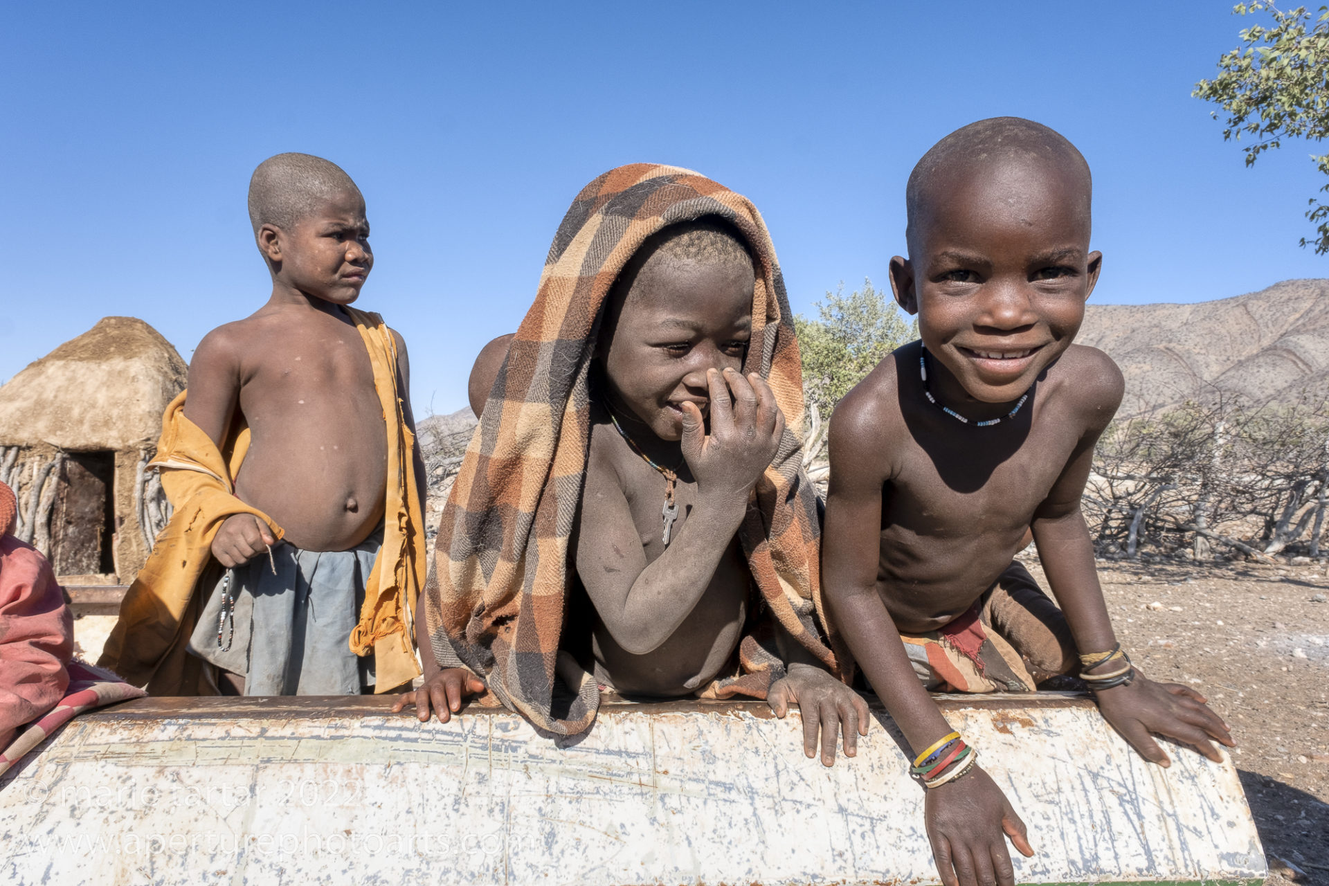 HImba boys playing in the bed of an abandoned truck bed in northern Namibia